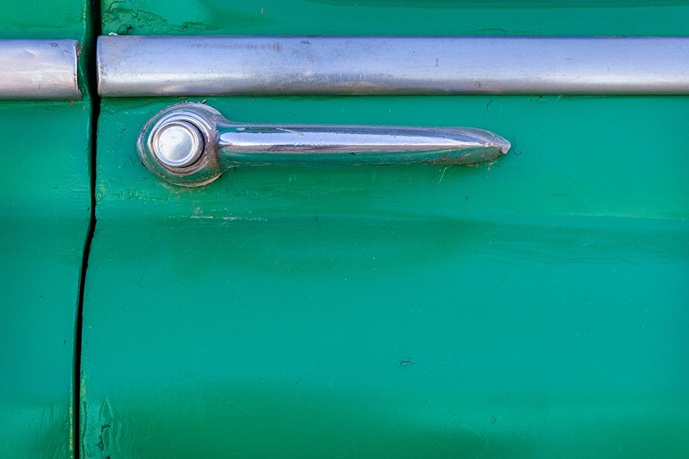 Detail of door handle on classic green car in Trinidad-Cuba